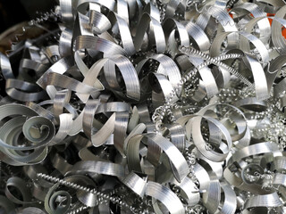 Steel scrap materials recycling. Aluminum chip waste after machining metal parts on a cnc lathe....