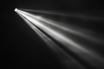 Close up of a single shaft of light on a dark backdrop