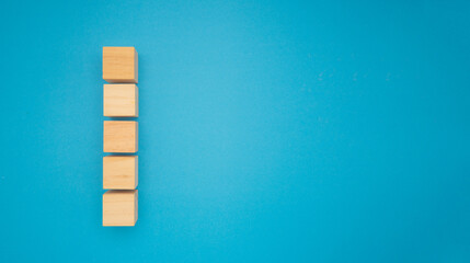 Five wooden cubes are on a blue background.