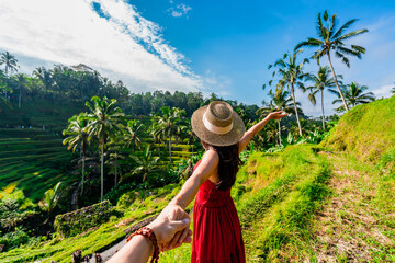 Young couple traveler looking at the beautiful tegalalang rice terrace in Bali, Indonesia