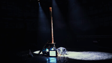 Dark empty stage with wooden pillar and tv monitor. Media. Preparation for the performance.