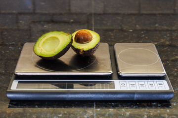 Avocado Halves on Kitchen Scale for Portion Control and Healthy Eating Habits