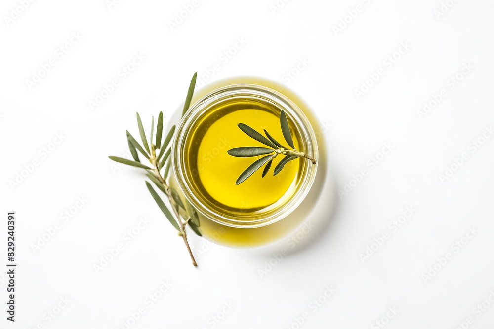 Wall mural Olive oil in a glass bowl with olive branch