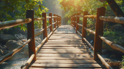 Obraz premium Long wooden bridge surrounded with tropical leaves crossing the rough river in the rainforest