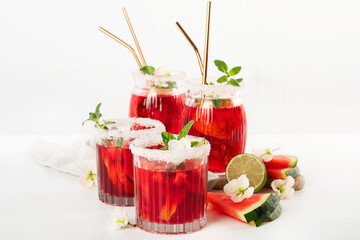 Watermelon drink in glasses with slices of watermelon.