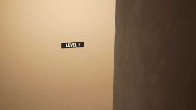 Simple wall with level I sign indoors