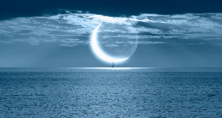A lonely yacht sails on the sea,  Crescent or new moon  in the background 