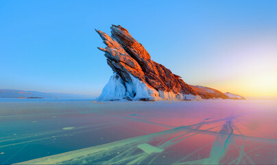 Ogoy island on winter Baikal lake with transparent cracked blue ice at sunrise - Baikal, Siberia, Russia