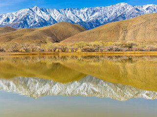 Reflections of The Foothills and Pier With The Sierra Nevada Mountain Range on Diaz Lake, Lone...