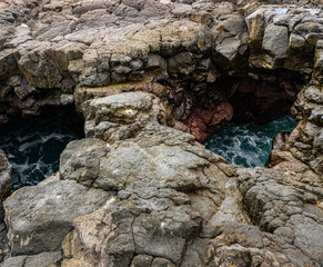 Sea Water Rushing Through Open Lava Tube on The Volcanic Coast of Hokulia Shoreline Park, Hawaii Island, Hawaii, USA