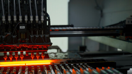 Factory machine at work: printed circuit board being assembled with automated mechanism. Creative....