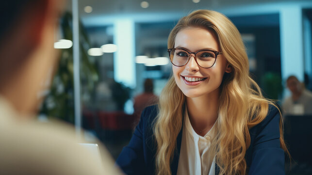A young beautiful female recruiter is conducting an interview. Portrait of a business woman at the moment of conversation and communication with colleagues