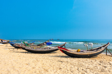 Boats with curved bows rest at Thuan An beach, Hue, waiting to go to sea. This is a means of transportation on the sea in Central Vietnam. © huythoai