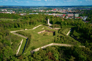 Aerial view of Prusy Fort in Nysa city on clear day, Star-shaped historical military fortress surrounded by lush greenery and the town in background. Tourist attraction in Poland