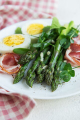 Fresh Asparagus and Prosciutto Salad Served With Boiled Eggs and Microgreens