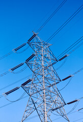 Low angle view of electricity transmission tower with overhead wires in Baghmundi, Purulia, West...