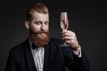 Elegant tuxedo man hold glass of champagne isolated on black. Celebrating success. Cheers. Bearded...