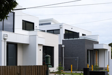 A newly built modern suburban home with a contemporary exterior design. The construction site of...