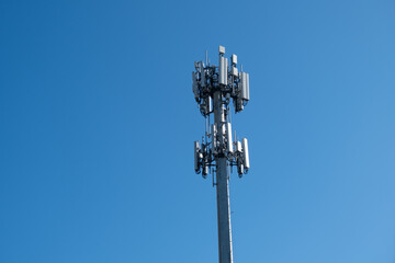 A cell tower or cell site, cellular base station, mounted with electric communications equipment...