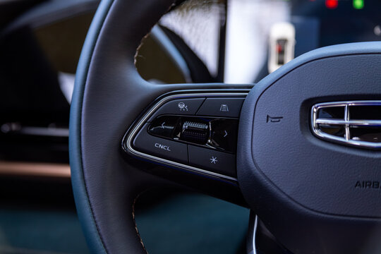 Novosibirsk, Russia -  May 15, 2024:  Geely Monjaro, Close up of car steering wheel with function buttons