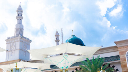 Big umbrella in the mosque with a blue sky background