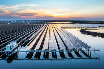 Solar power plant in the lake at sunset