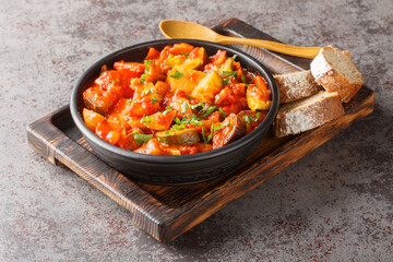 Summer Vegetable spicy stew of zucchini, potatoes, peppers, onions, tomatoes and eggplant close-up in a bowl on the table. Horizontal