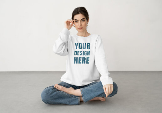 Mockup of woman cross legged wearing customizable sweatshirt