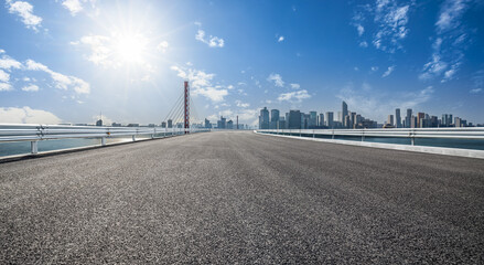 Empty asphalt road and modern city skyline background in Hangzhou