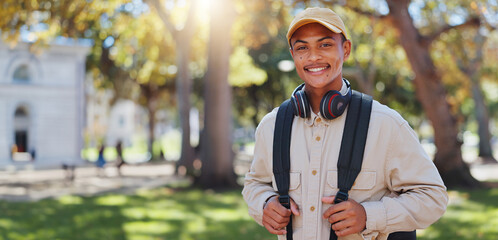 Travel, man and park portrait on college campus in New York with backpack and study break. Happy,...