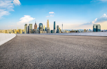 Empty asphalt road and modern city skyline background