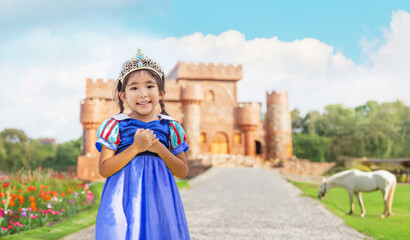 asian girls with princess dress girl closed her eyes and dreamed of a magical world with a prince's castle in the background fairy tale