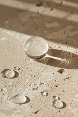 Single Clear Water Droplet on Creamy Beige Stone Surface with Natural Texture