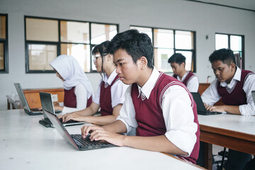 Fototapeta premium Asian Multiethnic High School Students At The Computer Lab