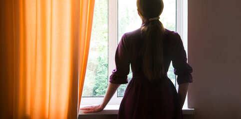 Praying woman at the window