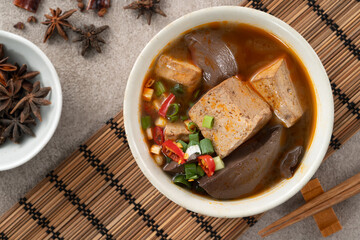 Spicy duck blood jelly soup and stinky tofu with scallion and chili pepper topping.