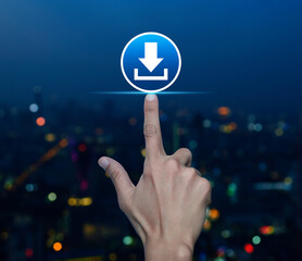 Hand pressing download flat icon over blur colorful night light modern city tower and skyscraper,...
