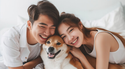 Portrait of a happy young family or Pet lovers are playing with dog and taking care each other , hug dog in  owner's arms. having a dog like a kids.