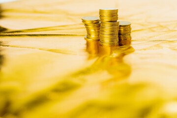 business and finance investment and saving activity with close up gold coin arrange on gold glitter...