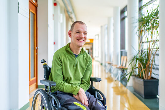 Disabled man in wheelchair in the university - Powered by Adobe