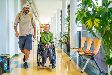 Man with physical disability and friend chatting in the university