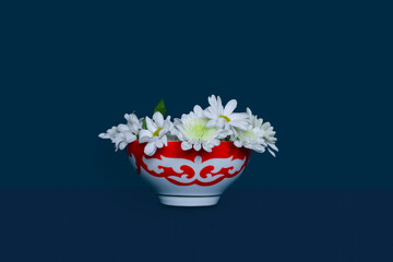 Kazakh traditional bowl — piala with national ornament filled with blooming peonies. Pefrect photo for Nauryz greetings