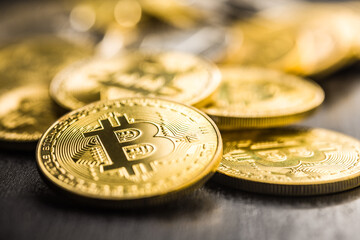 Bitcoin gold coin on black table.