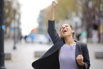 Excited executive celebrating in the street