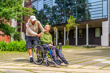 Man with special needs and friend walking along university campus