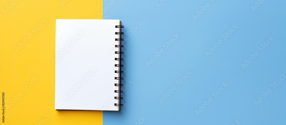 Aufkleber flat lay design with blank on note book yellow and blue background. copy space available