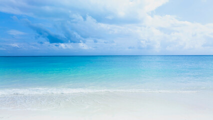 Ocean Tropical Beach with the soft wave water of the sea on the sandy beach background