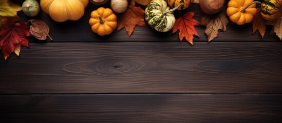 Autumn composition with dry leaves and ripe pumpkins on a dark wooden table Top view Copy space - Powered by Adobe