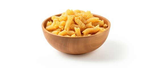 Raw italian cellentani pasta in wooden bowl isolated on white background top view. copy space available
