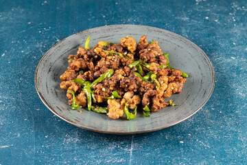 Stir Fried Green Chilli Chicken Dry served in plate isolated on navy background side view of bangladeshi food